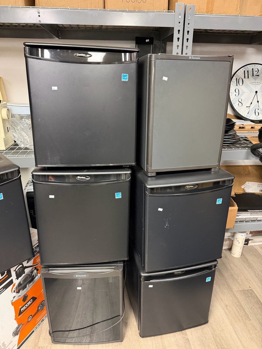 Stacked hotel mini fridges from a hotel liquidation