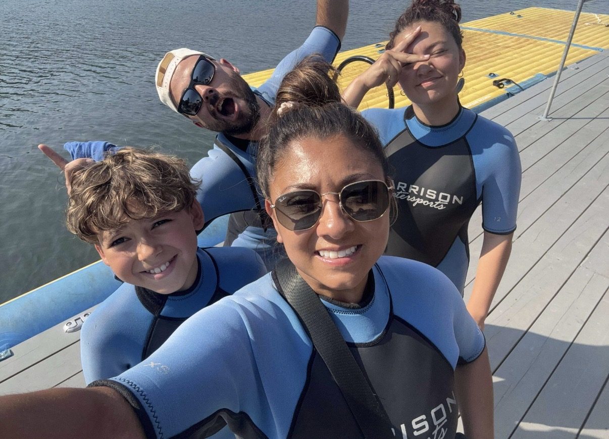 The Metzger family together on a dock by the water